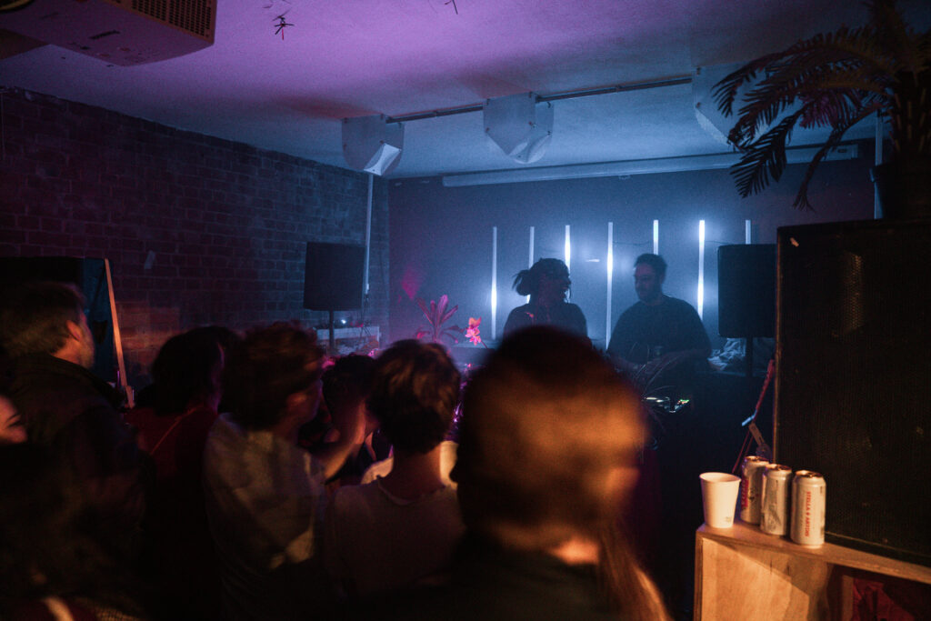 OK WIlliams & another DJ behind turntable at a party